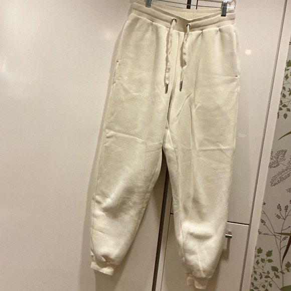 AMI Paris logo-patch drawstring track pants. Size S Cream White.